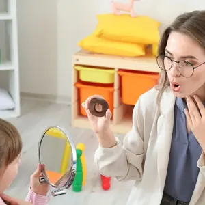 logopeda y niña realizando ejercicios con la lengua en terapia de la voz